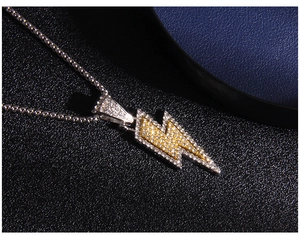 Close-up of lightning bolt pendant with silver metal and inlaid white and yellow rhinestones