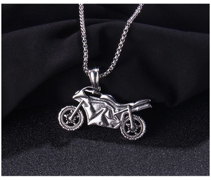 Detailed close-up of a vintage motorcycle pendant in polished silver stainless steel