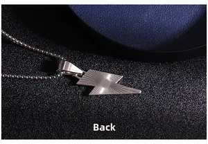 Detail view of lightning bolt pendant back with textured sunburst pattern and steel chain