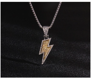 Close-up of hip-hop lightning pendant featuring white and yellow zircon stone inlay