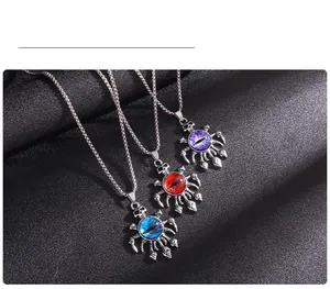 Detail of gothic evil eye skull pendants in blue, red, and purple with punk claw design