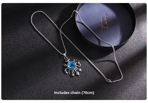 Detail of blue evil eye pendant with skull design and 70cm stainless steel bead chain