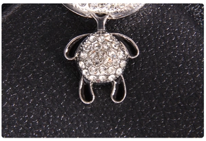 Macro shot of cute panda charm with sparkling rhinestones and black enamel detail