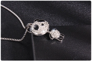 Detailed close-up of a silver panda pendant with sparkling white rhinestones and black enamel