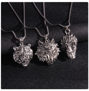Detailed view of vintage wolf, tiger, and lion head pendants with antique silver finish