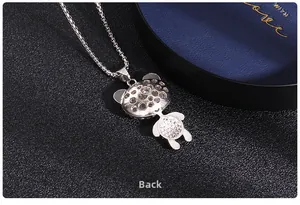 Detail view of the silver-tone panda pendant back with hollowed-out craftsmanship