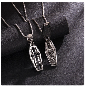 Macro shot of Gothic coffin pendant with skull detail and interior skeleton engraving