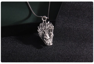 Detailed close-up of antique silver beast head pendant with intricate punk style texture