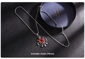 Detail of punk skull claw pendant with red evil eye on 70cm silver chain necklace