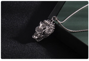 Detailed view of a vintage silver wolf head pendant with intricate fur texture on a metal chain