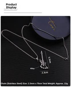 Detail of guitar pendant in alloy and stainless steel chain on a dark textured surface