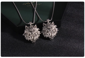 Detailed macro view of vintage silver wolf head pendant with fine engraved textures