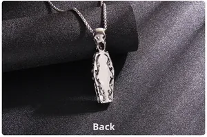 Detailed view of gothic coffin pendant with skull relief on silver box chain