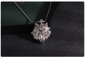 Macro shot of silver wolf head pendant with detailed fur texture on round bead chain