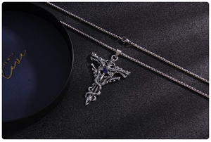 Detailed macro view of vintage gothic dragon sword pendant with blue gemstone