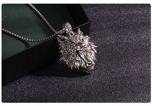 Detailed macro view of the silver wolf head pendant with intricate carved textures