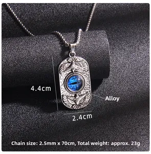 Detail of owl pattern stainless steel pendant with blue evil eye on black background