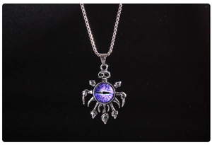 Gothic silver skull pendant featuring a purple textured evil eye on a fine chain