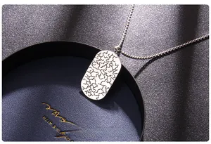 Macro shot of the silver evil eye necklace back showing intricate etched metal textures