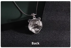 Macro back view of silver panda head pendant with honeycomb texture and fine chain