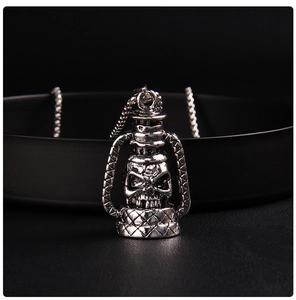 Close-up of vintage silver kerosene lamp pendant with gothic skull relief detail