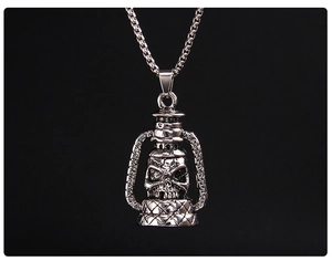 Macro shot of vintage silver skull kerosene lamp pendant with gothic textured metal finish