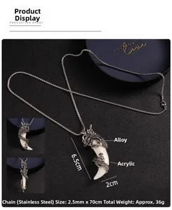 Detailed view of vintage dragon claw pendant with acrylic tusk on a steel chain