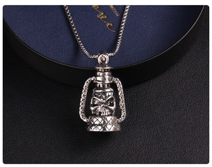 Macro view of vintage kerosene lamp skull pendant on a box chain for men