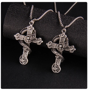 Detail view of vintage silver punk cross necklace with skull and dragon motifs on leather