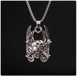 Close-up of punk style skull pendant with angel wings and sunglasses on a metal chain