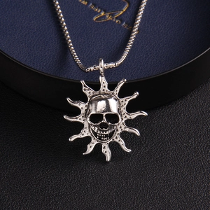 Retro silver flame skull pendant necklace with sunburst spikes on a snake chain