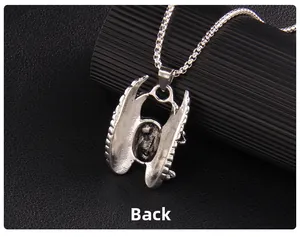 Detailed back view of the vintage silver punk skull wing pendant with aged metal texture