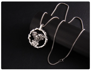 Detail of gothic skull necklace with V-engine pendant and heavy metal biker chain link