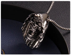 Close-up of a gothic skull pendant with vintage silver finish on a square box chain