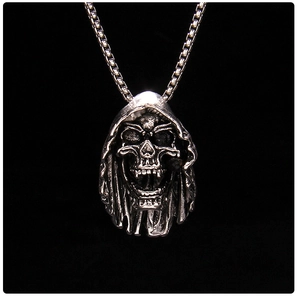 Detailed close-up of dark gothic skull pendant in vintage silver on a box chain