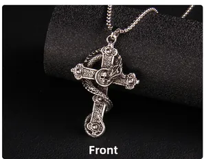 Front view detail of vintage punk cross pendant with dragon snake and skull relief