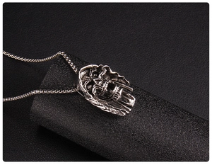 Detailed close-up of dark style reaper skull pendant with stainless steel box chain