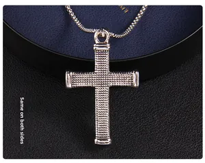 Detail of vintage silver cross necklace showing same textured pattern on both sides