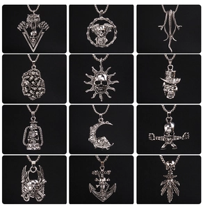 Macro view of gothic punk pendants featuring skull, tiger, and vintage sun patterns