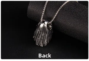 Macro view of the back detail of a retro silver skull pendant with a box chain