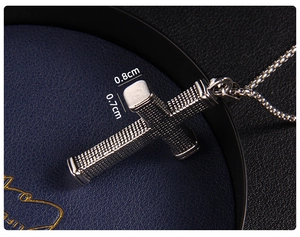 Macro view showing 0.8cm width and grid texture of the vintage stainless steel cross pendant