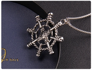 Macro shot of silver retro anchor nautical helm pendant with detailed oxidized finish