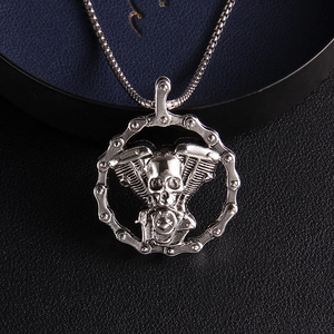 Gothic engine skull pendant necklace with silver bike chain border on leather background