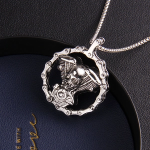 Gothic skull engine pendant necklace with motorcycle chain trim on blue leather