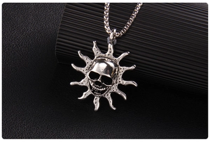 Macro view of punk style skull sunburst pendant with vintage matte metal finish