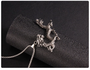Macro detail of silver dragon pendant necklace with realistic scale textures and box chain