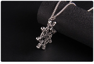 Macro shot of silver retro anchor rudder pendant with nautical details on black background