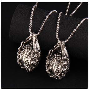 Detailed view of silver Buddha head pendants with vintage distressed metal textures