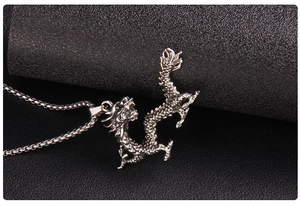 Detailed view of the vintage dragon pendant with intricate scales and antique finish