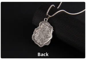 Macro detail of the silver metal pendant back view with textured wave patterns